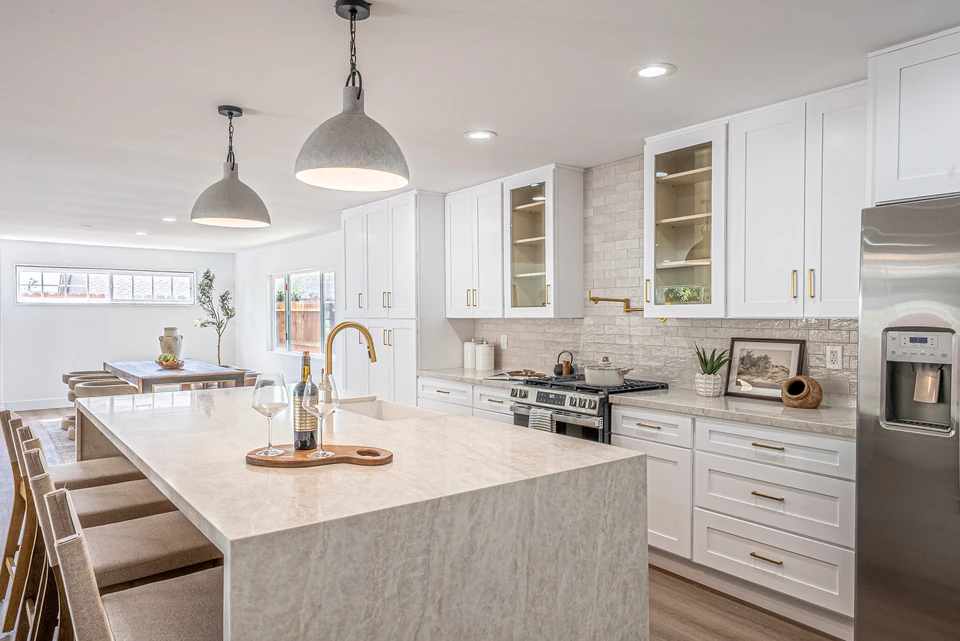 Bright kitchen with a stone island and pendant lighting